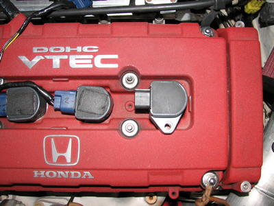Valve cover with modified and unmodified coils